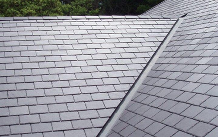 Grey slate roof slopes meeting neatly along a metal valley gutter