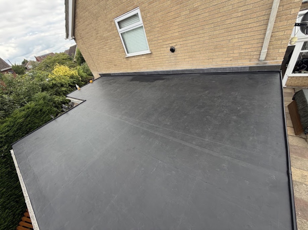 Newly installed EPDM rubber flat roof with clean edge trims and flashing