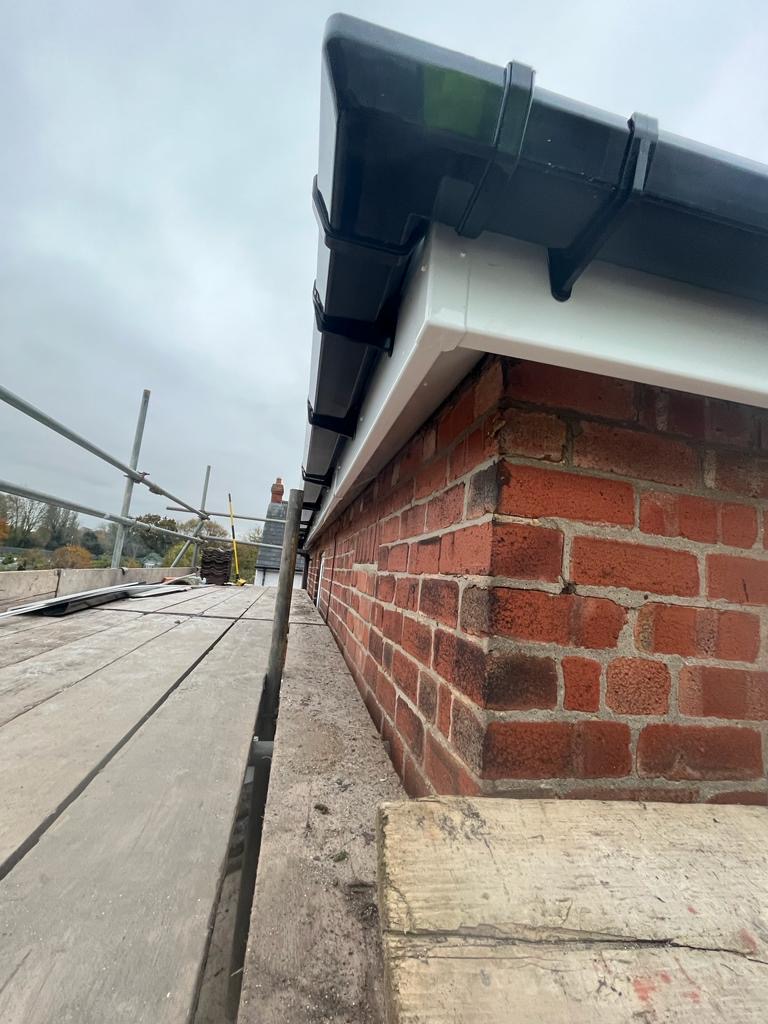 Newly fitted white fascias and soffits with black guttering